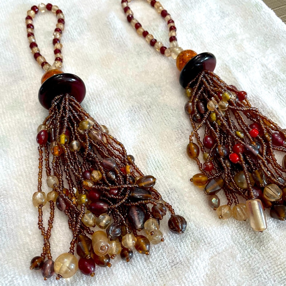 Curtain tassel  pair. Glass beads. Warm/ neutral tones with red accent.   Used.